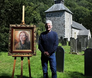 Professional artist Stephen Hopper with his oil painting of Saint Melangell at the pilgrim church of St Melangell